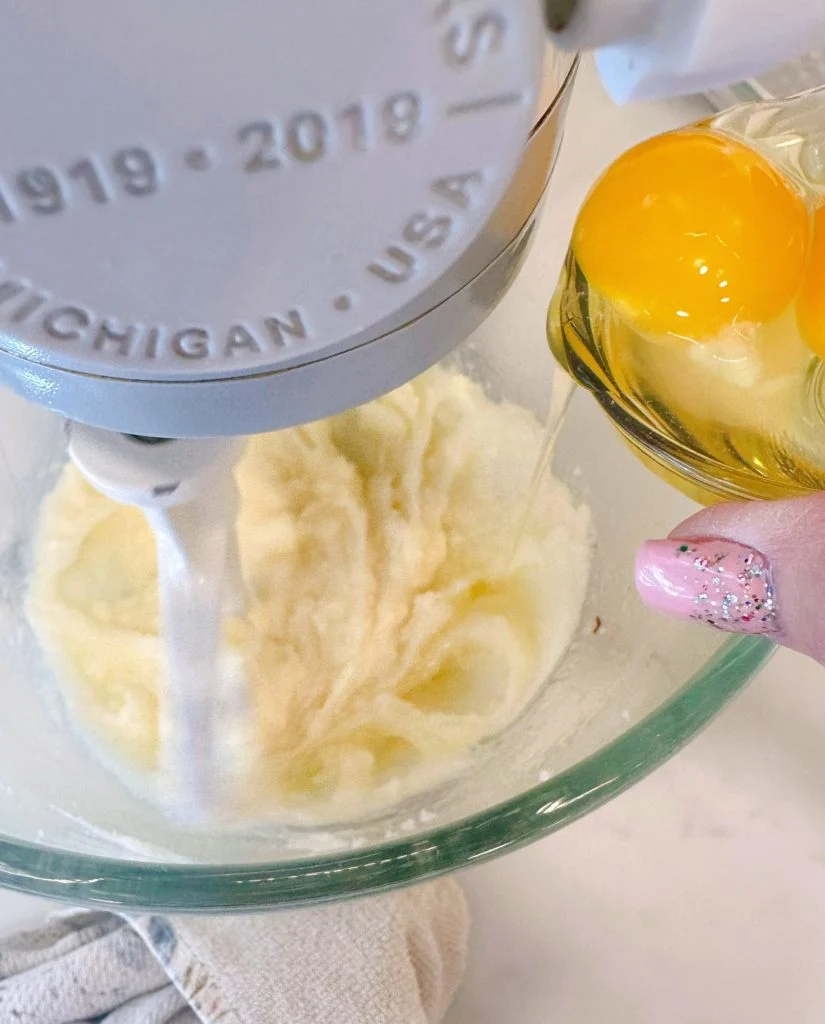 Add eggs to butter and sugar mixture.