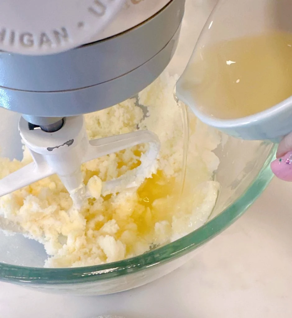 Beating sugar, butter, and oil together in stand mixer.