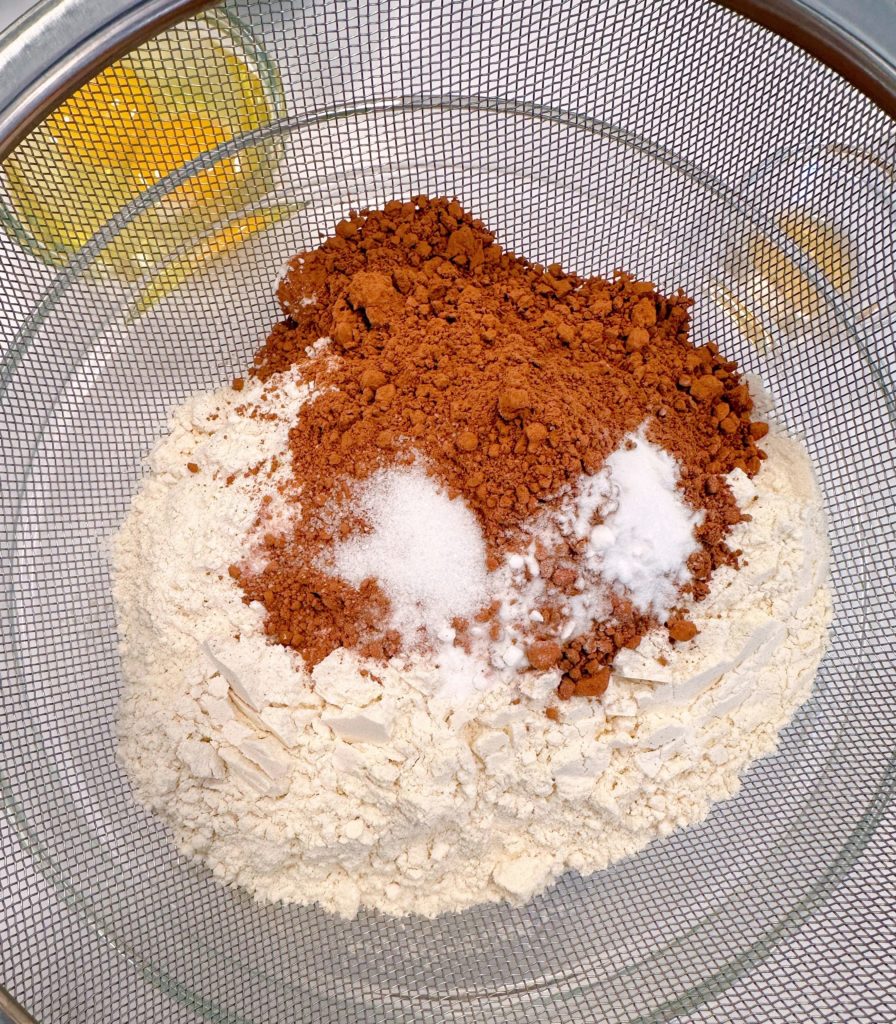 Dry ingredients in a medium-sized bowl for chocolate zucchini cake.