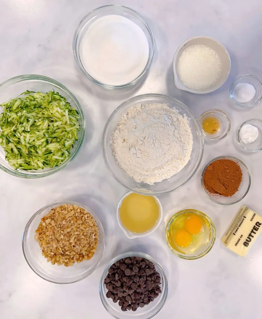 Ingredients for Chocolate Zucchini Nut Cake in bowls.