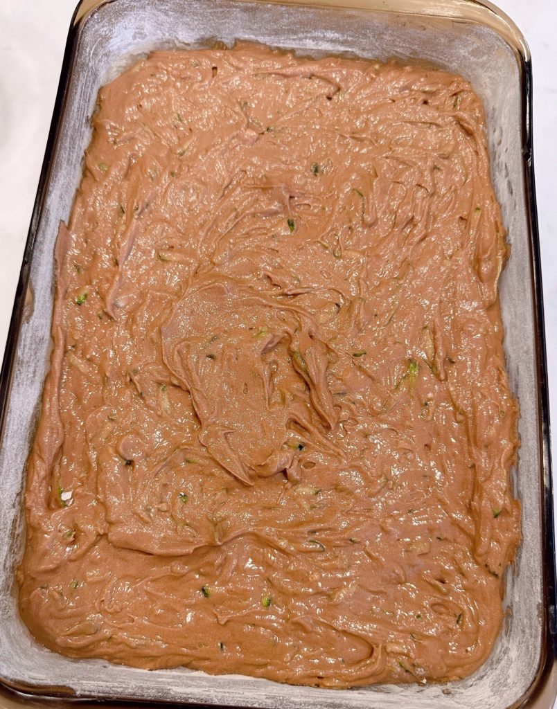 Cake batter poured into greased and floured cake pan.