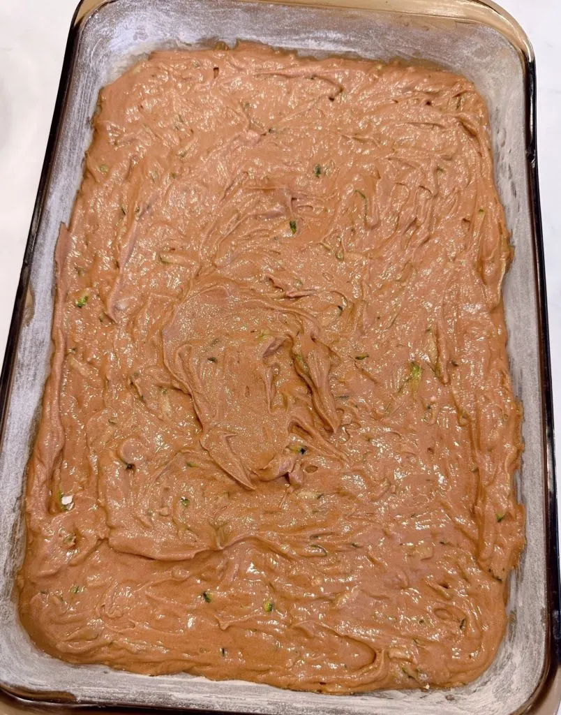 Cake batter poured into greased and floured cake pan.