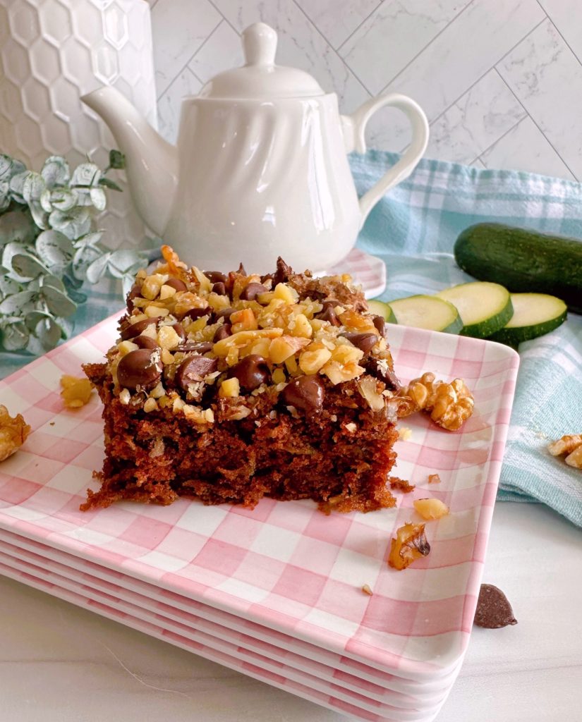 Chocolate cake with tea pot in the background.