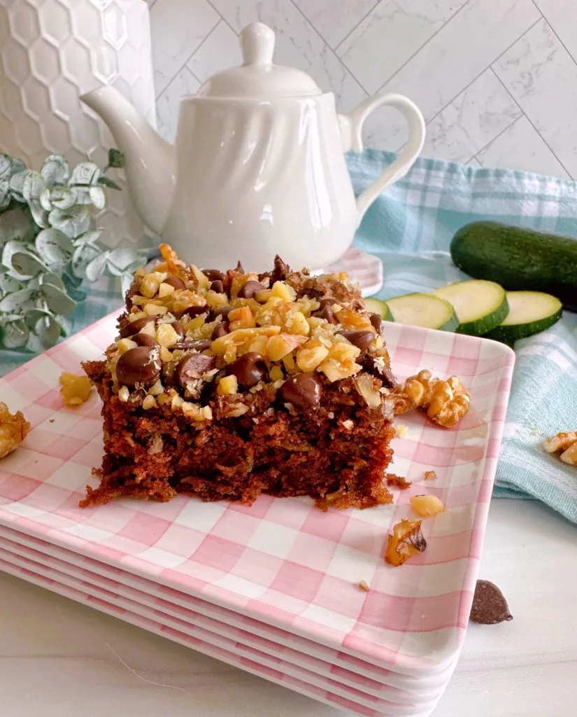 Chocolate cake with tea pot in the background.