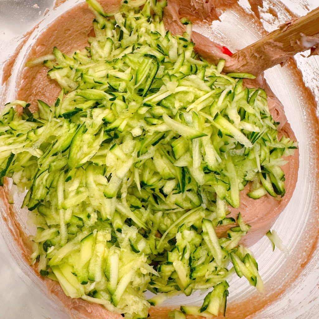 Adding squash to cake mix batter.