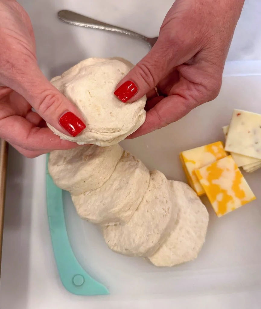 Place the top of the biscuit over the sausage and cheese.