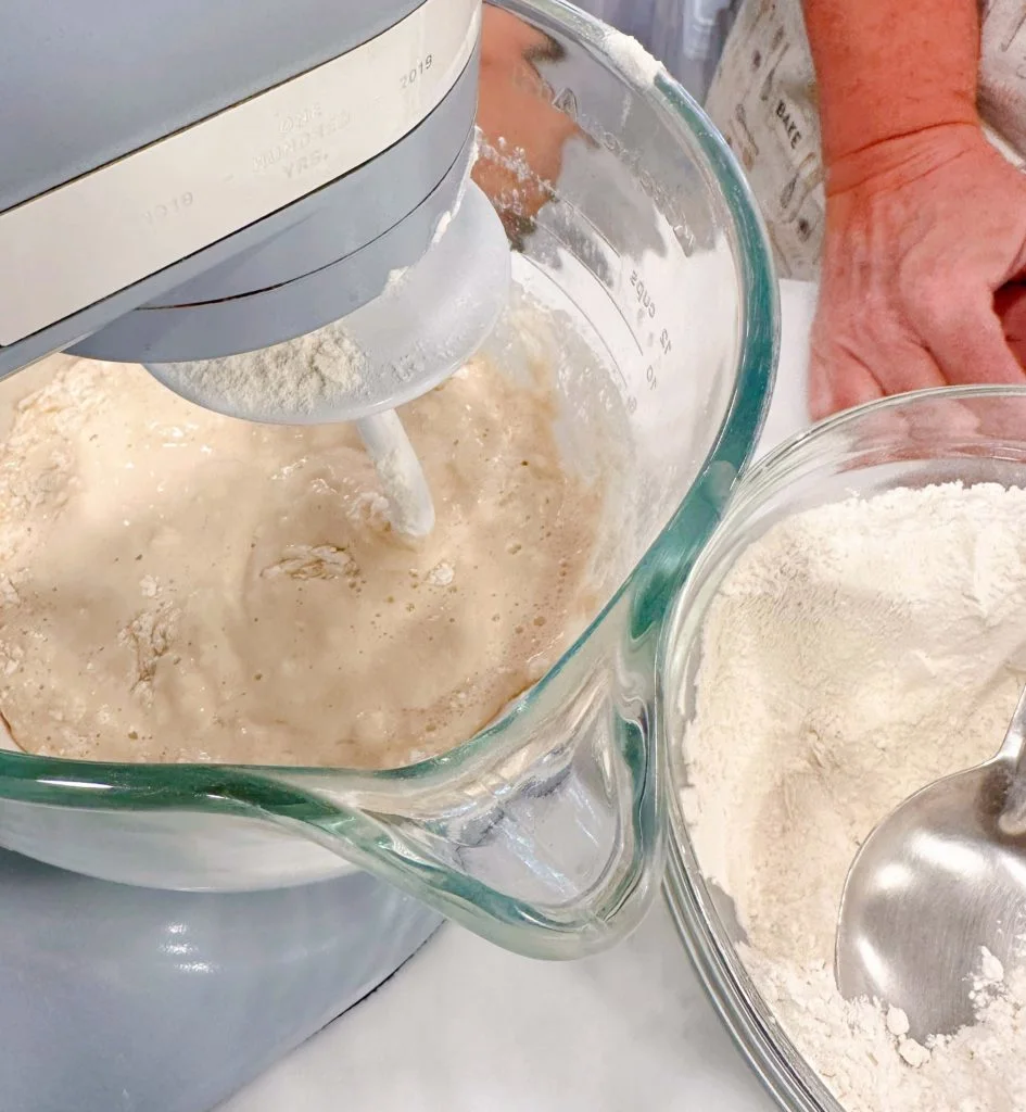 Add 3 cups of flour to the wet ingredients.