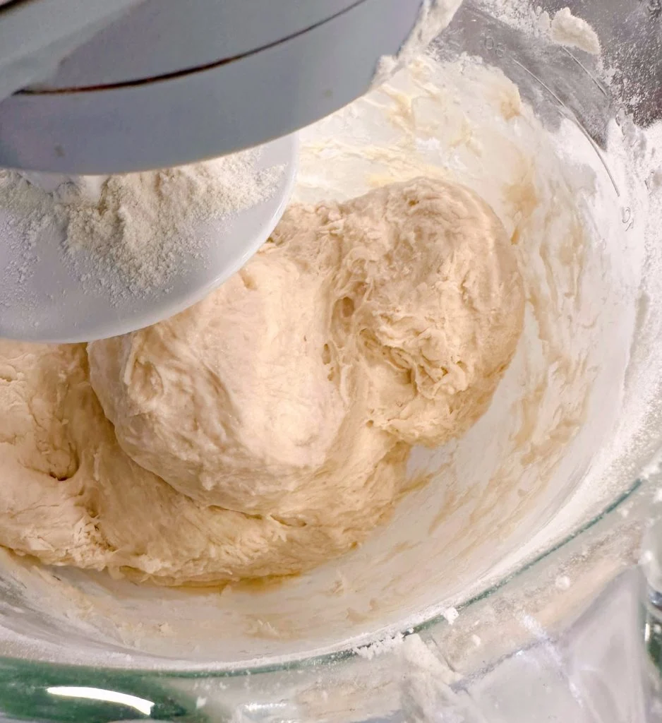 Add the next three cups of flour to the mixing bowl.