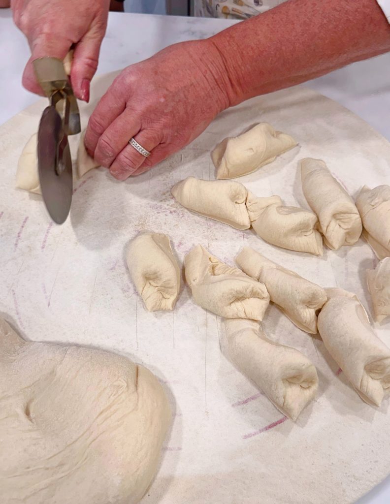 Dough cut in half, then cut into smaller sections to form breadsticks.