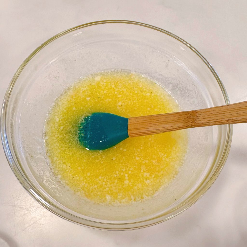 Garlic butter in small glass bowl.
