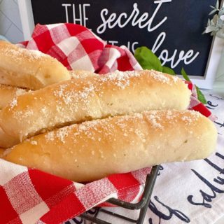 Easy Homemade Garlic Breadsticks in a basket with a red and white checked napkin.