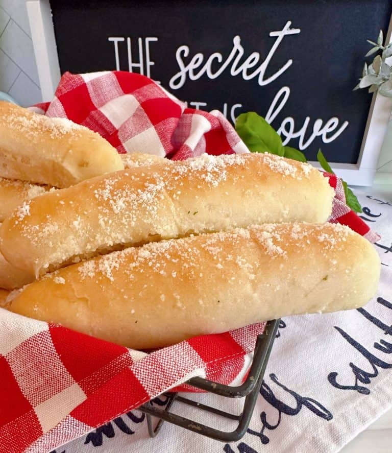 Easy Homemade Garlic Breadsticks in a basket with a red and white checked napkin.