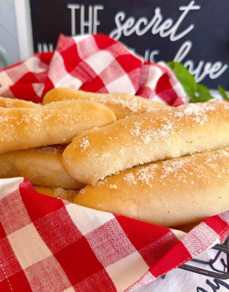 Basket full of soft homemade breadsticks.