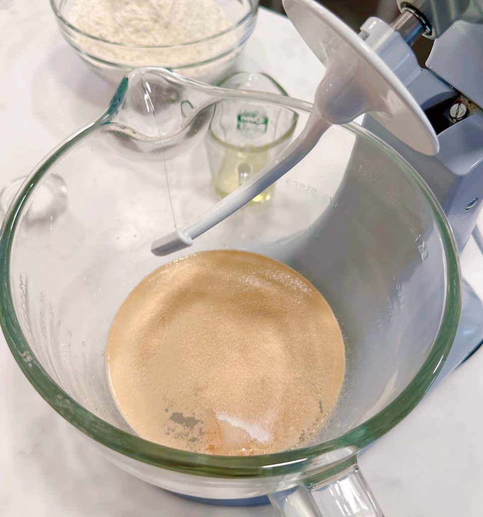 Yeast sprinkled over the top of the hot water.