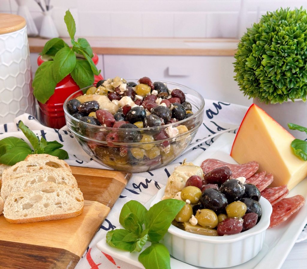 Marinated Olives and feta cheese on a cheese board spread.
