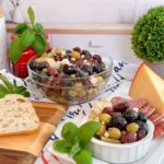 Marinated Olives and feta cheese on a cheese board spread.