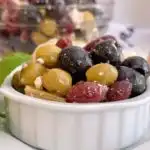 Chilled marinated olives in a small serving dish.
