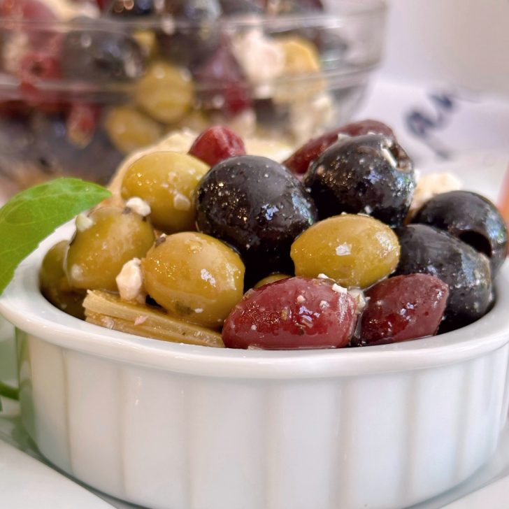 Chilled marinated olives in a small serving dish.