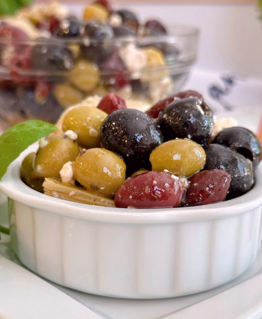 Chilled marinated olives in a small serving dish.