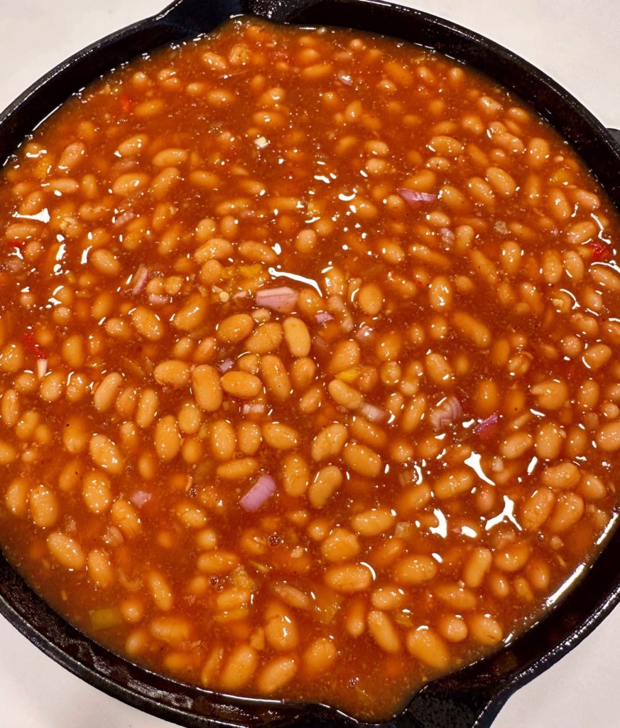 Bean mixture poured into prepared skillet for baking.