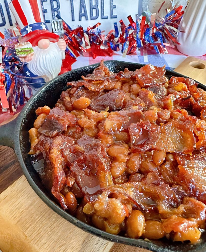 Oven baked beans up close in a skillet.