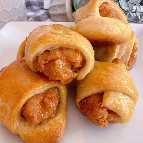 Crescent roll dough wrapped around chicken nuggets.