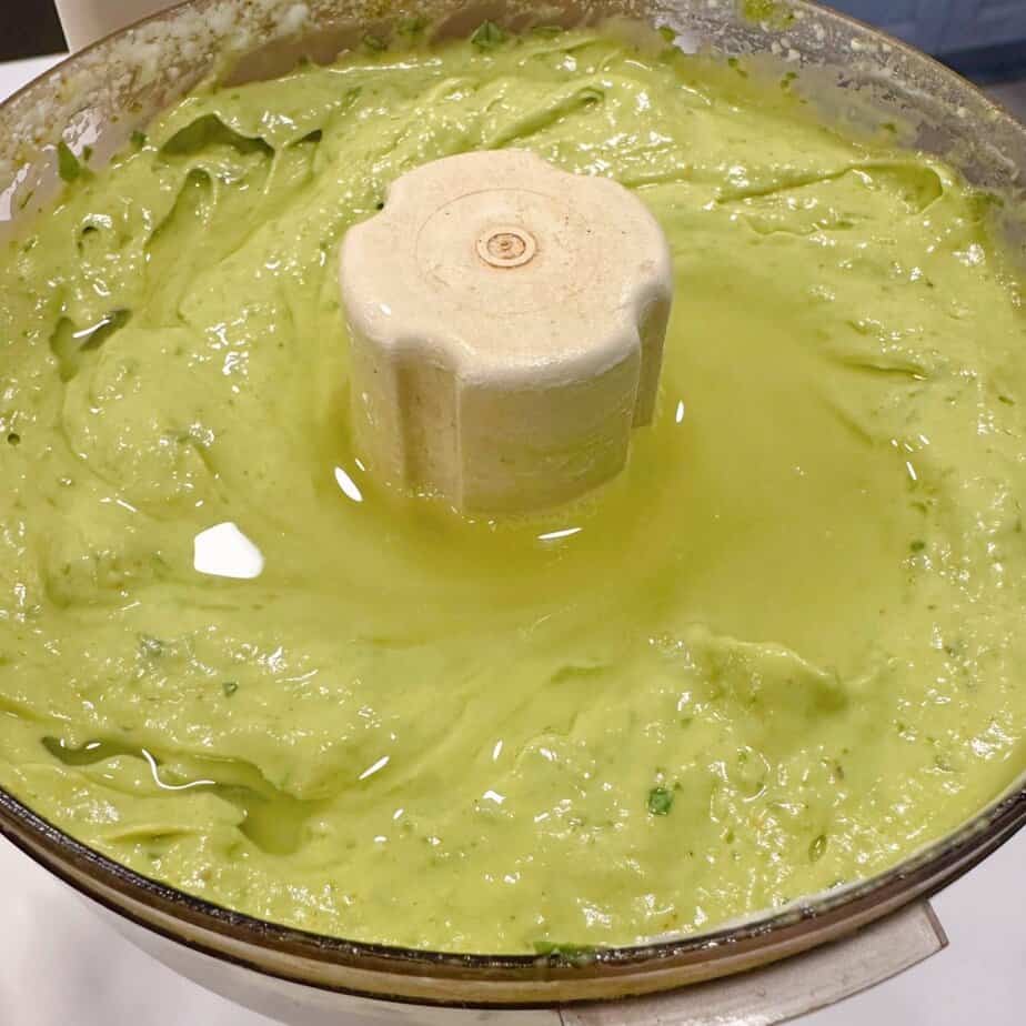 Adding additional lime juice to avocado sauce.