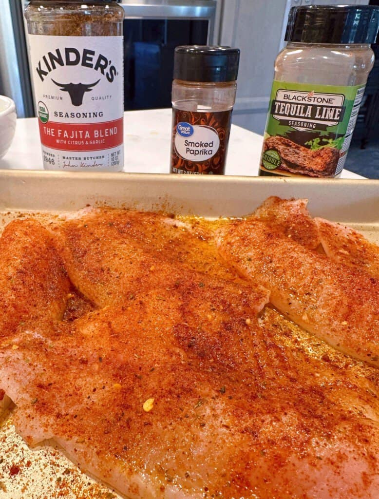 Seasoned Tilapia on a small cookie sheet.