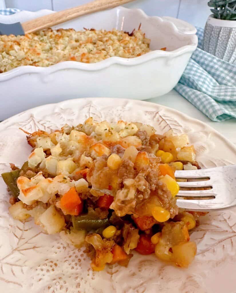 Fork full of Layered Beef and Potato casserole.