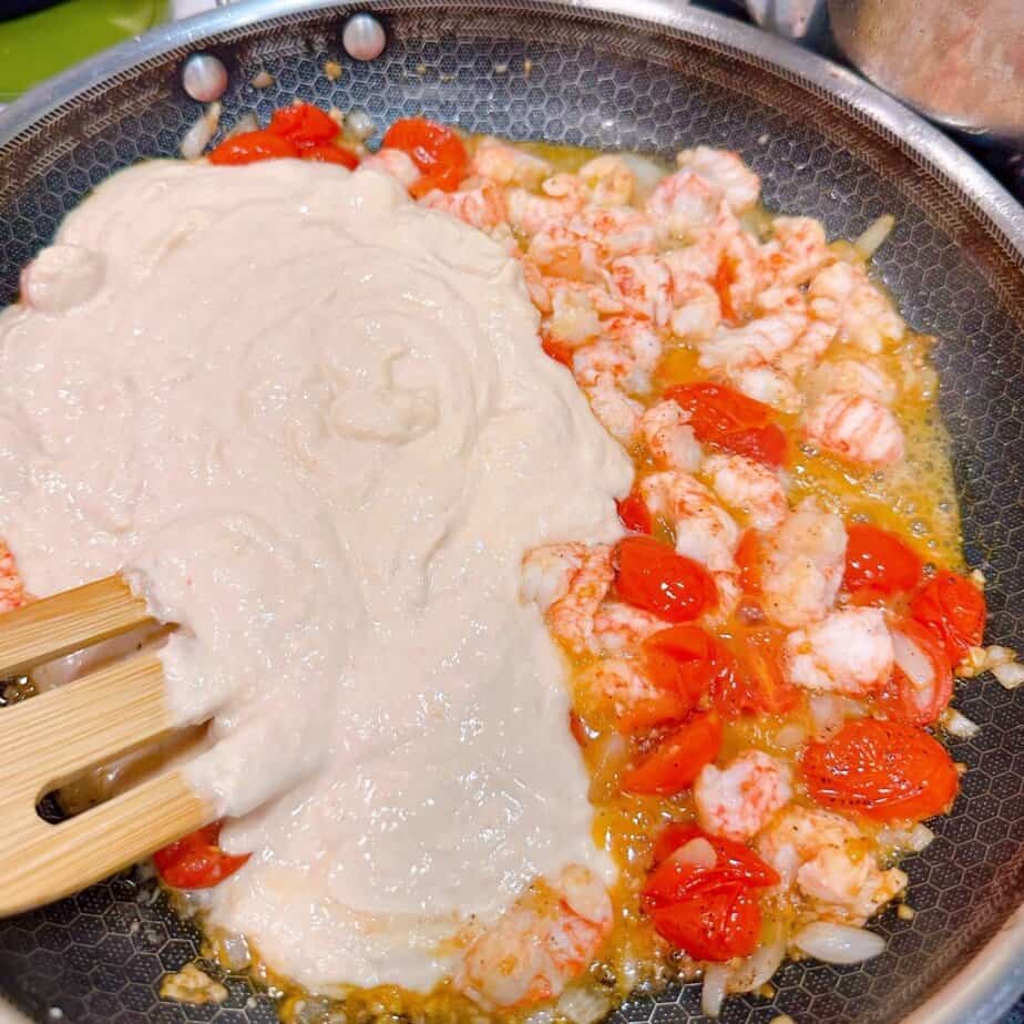 Adding lobster bisque to the sauce.