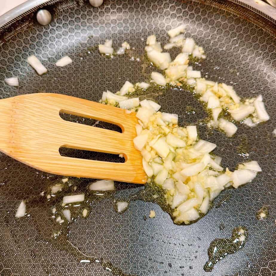 Cook onions and garlic in skillet over stove.