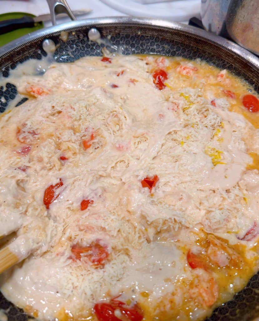 Adding cheese, lemon zest, and lemon juice.
