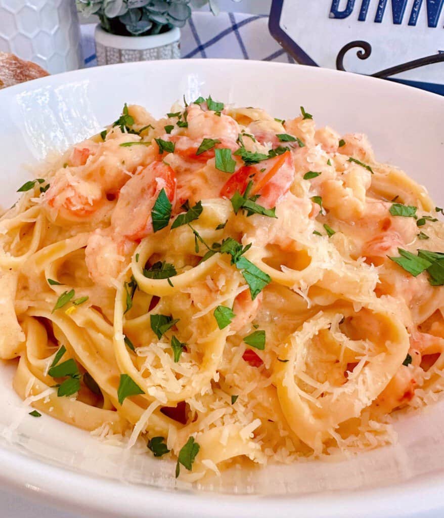 Lobster Bisque Pasta with garnish in a white serving bowl.
