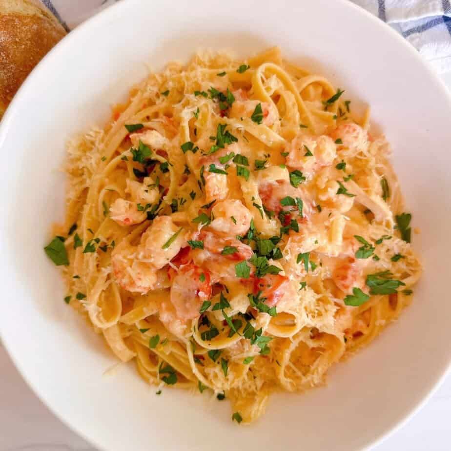 Creamy Lobster Bisque Pasta in a beautiful white serving dish. A viral Trader Joe's recipe.