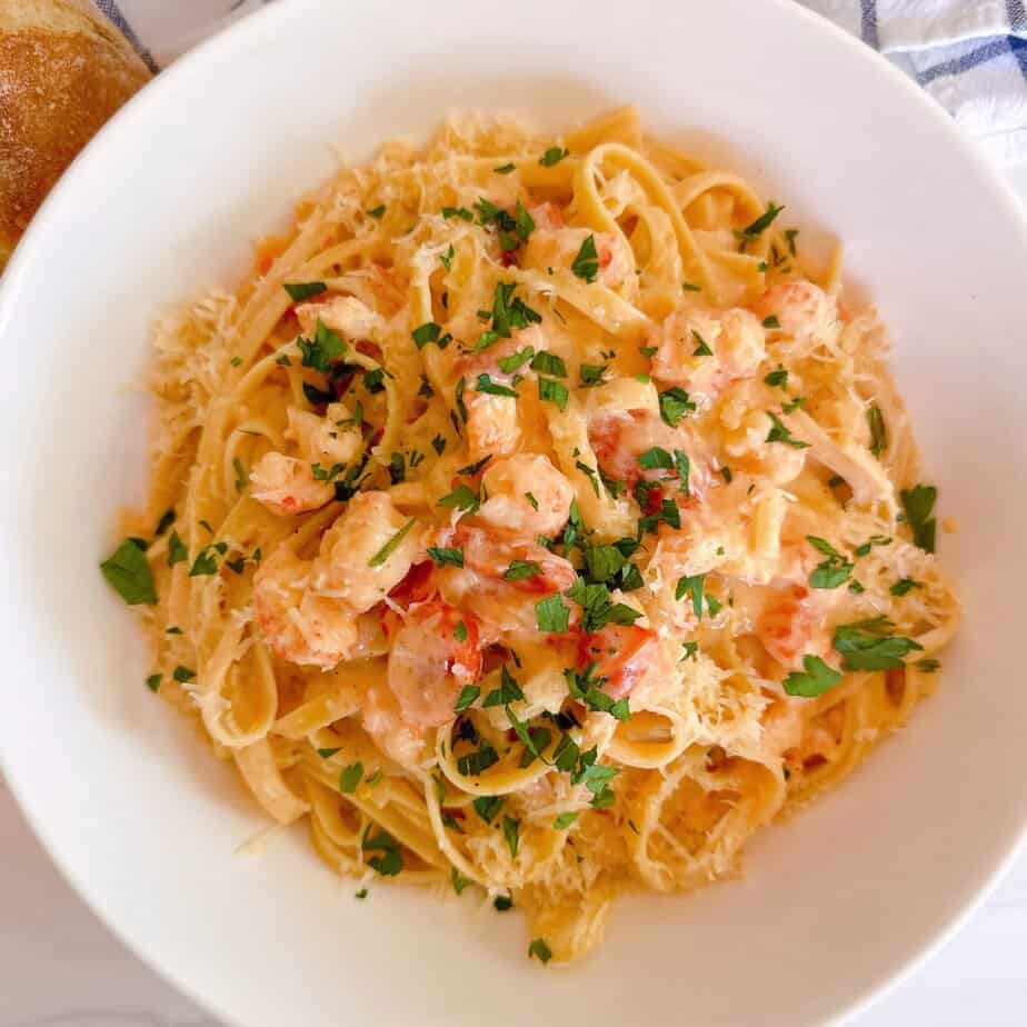 Creamy Lobster Bisque Pasta in a beautiful white serving dish. A viral Trader Joe's recipe.
