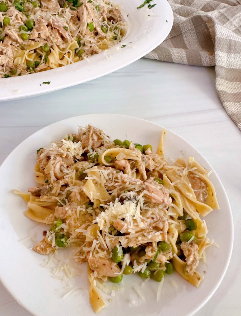 Serving of Chicken Mushroom pasta with bowl full in the back ground.