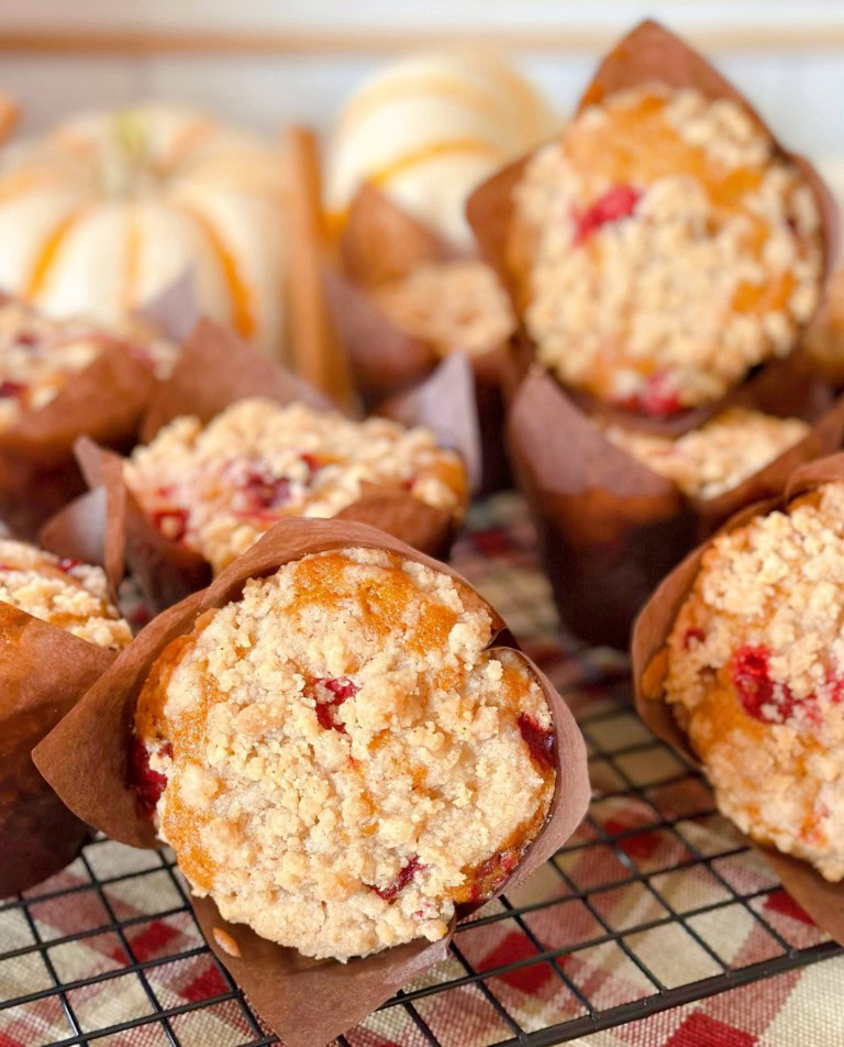 Pumpkin Cranberry Streusel Muffins on a cooling rack.