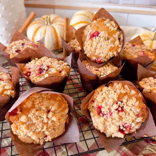 Cranberry Muffins piled on a cooling rack.