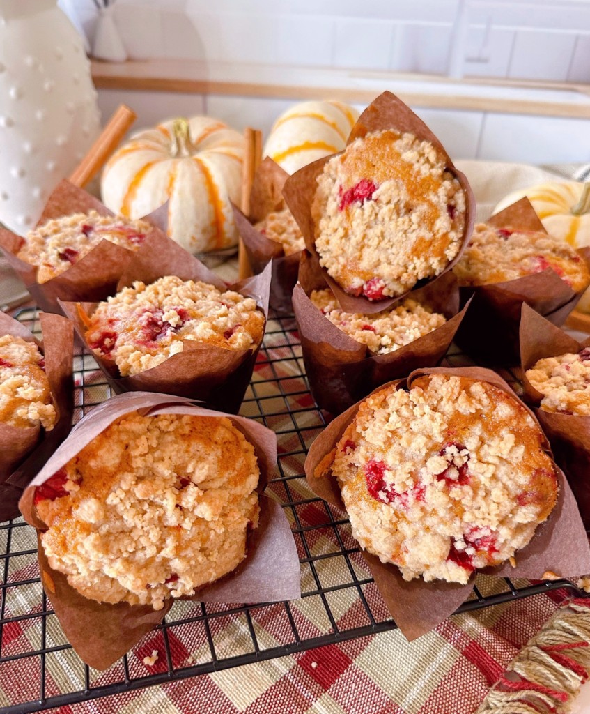 Cranberry Muffins piled on a cooling rack.