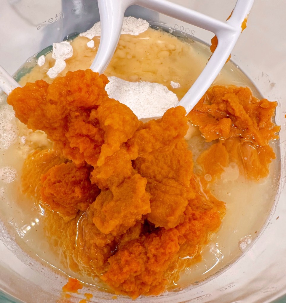 Wet ingredients being added to dry in mixing bowl.