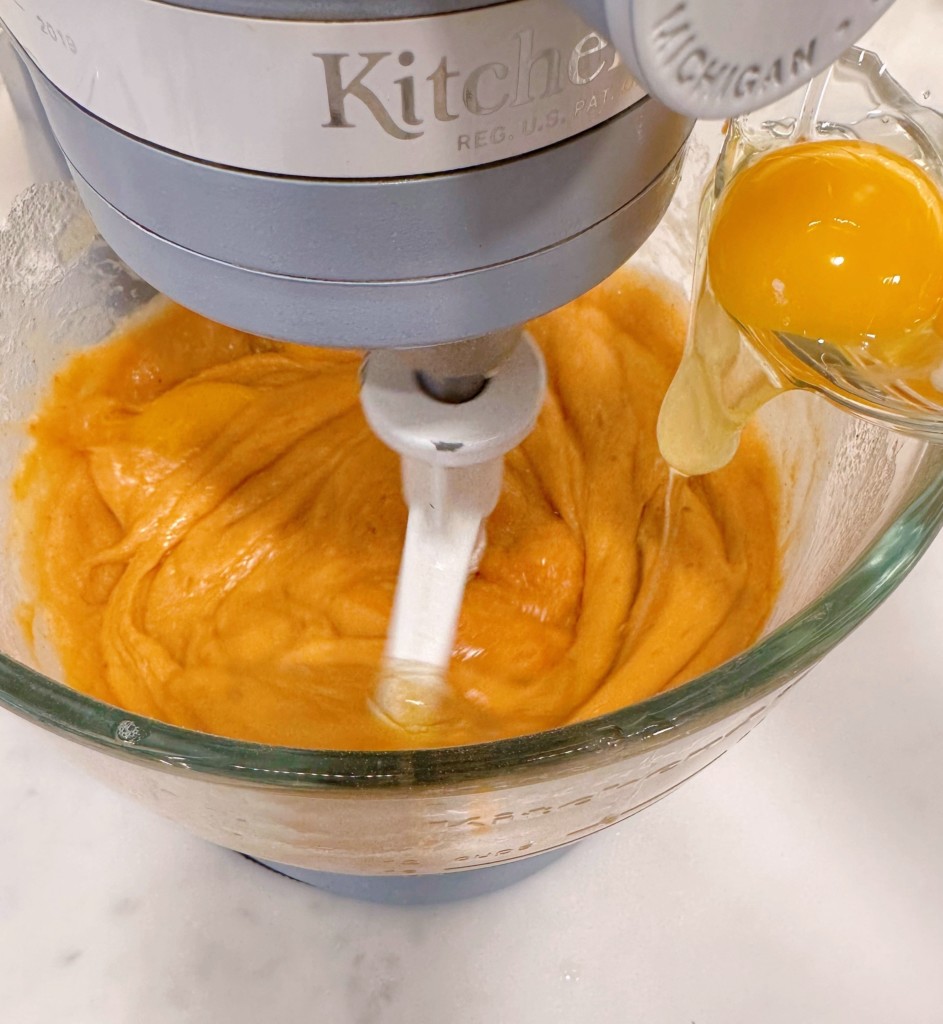 Add eggs one at a time to the pumpkin batter.