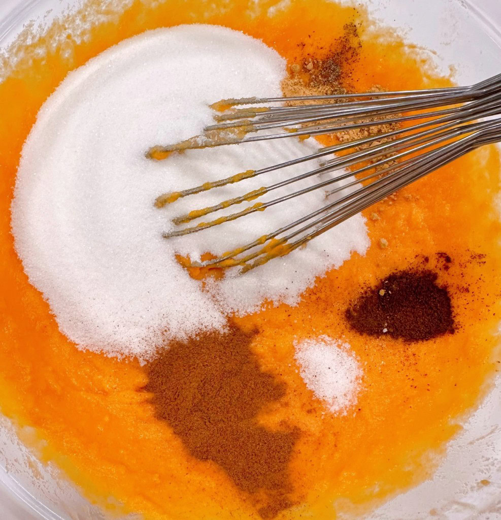 Adding in spices and sugar to sweet potato and egg mixture.