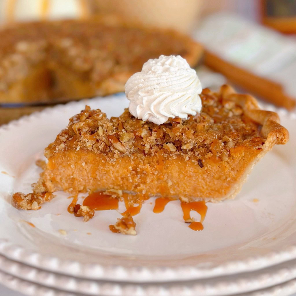 Slice of sweet potato pie with whipped cream.