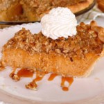 Sweet Potato Pecan Pie slice with vanilla bean whipped cream and a drizzle of salted caramel sauce.