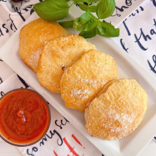 Pepperoni stuffed biscuits with dipping sauce.