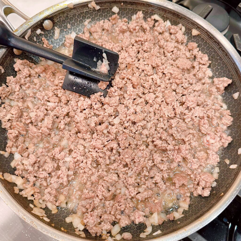 Beef cooked and no longer pink.