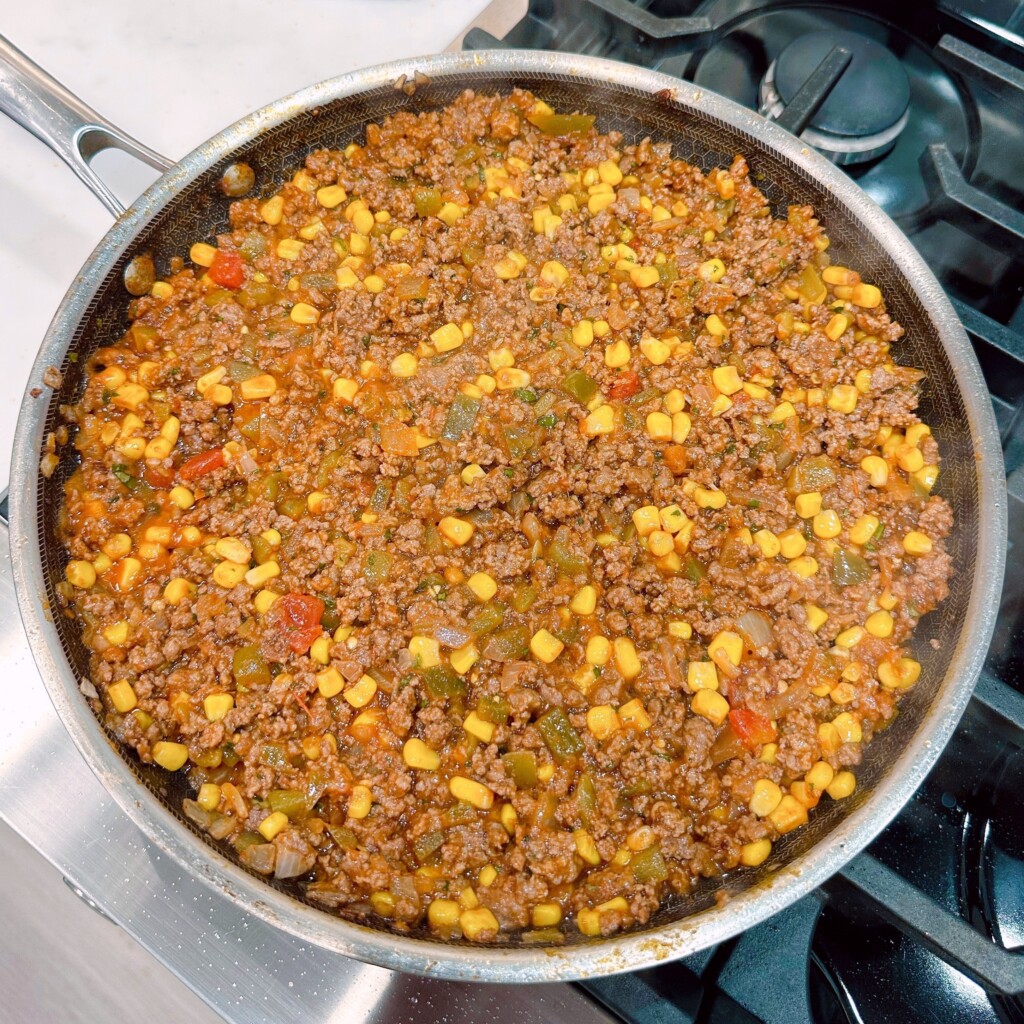 Sloppy Joe mixture in a skillet spread evenly.