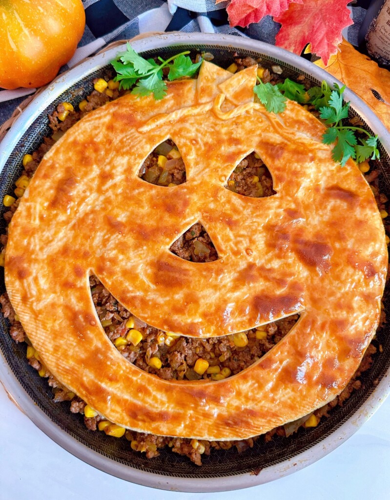Jack-o'-lantern face on top of meat mixture.