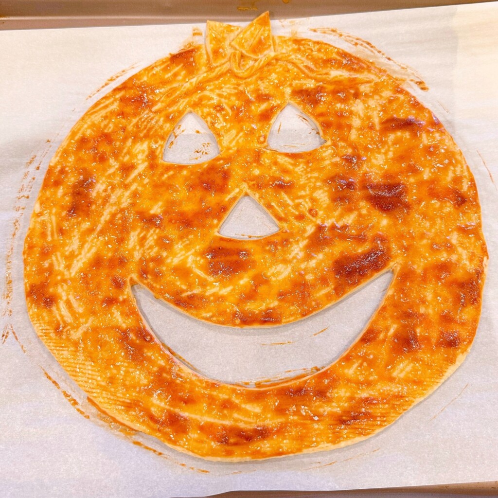 Baked Jack-o'-lantern face on baking sheet.