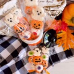 Overhead shot of Halloween Marshmallow Pops in a jar and on the table.